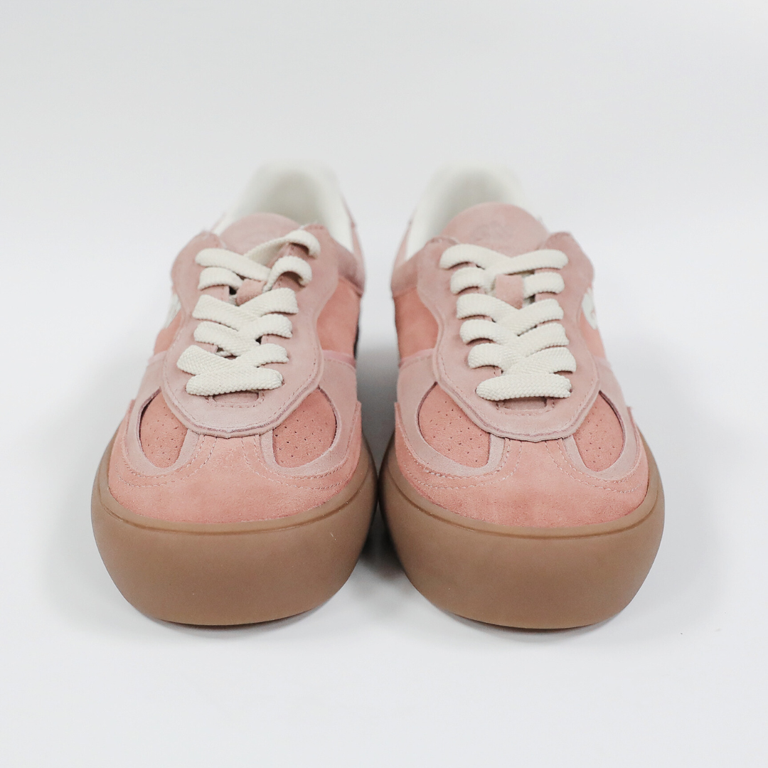 Rosa Sneaker mit weißen Schnürsenkeln und brauner Sohle auf weißem Hintergrund.