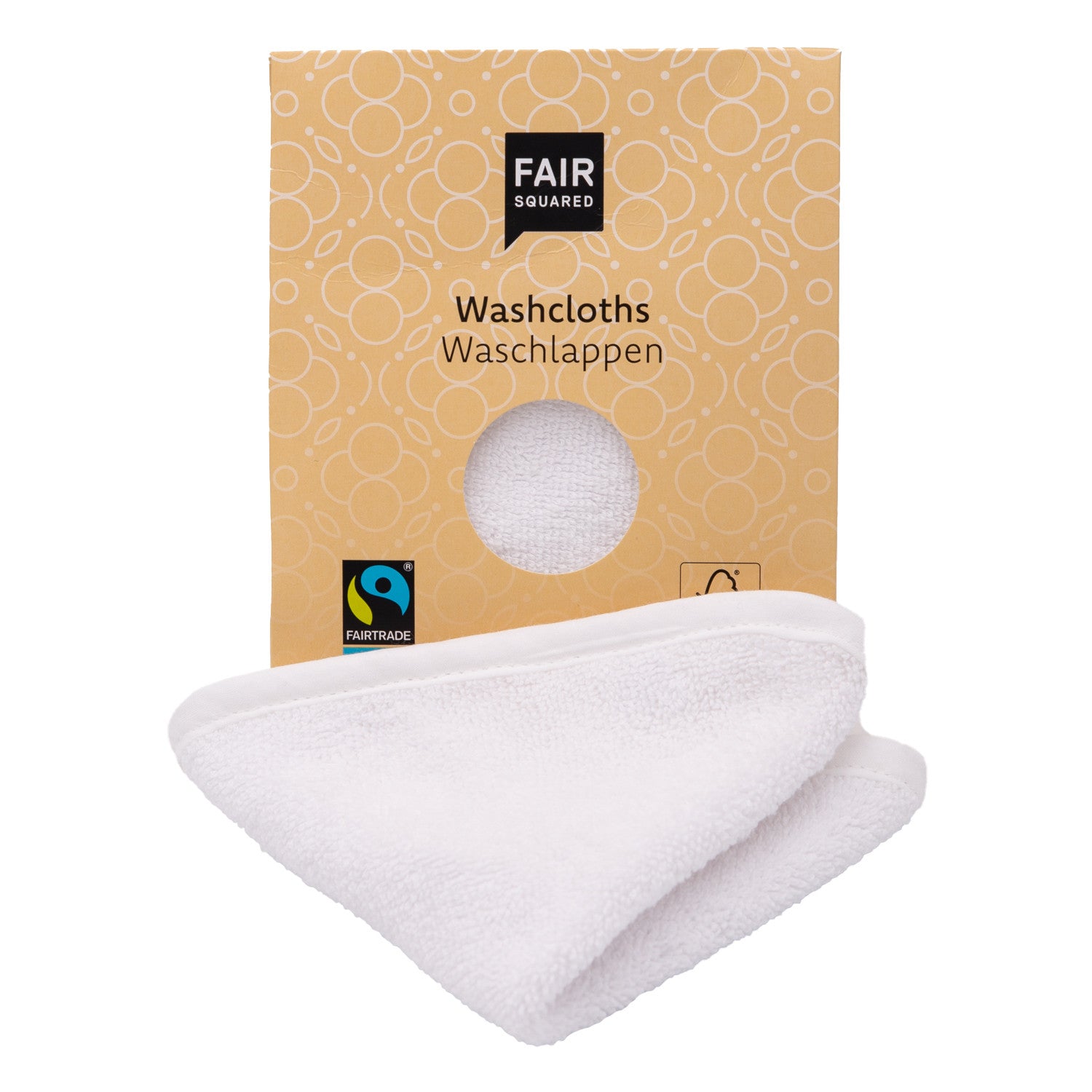 Eine Fair-Squared-Schachtel mit der Aufschrift "Washcloths" (Waschlappen) mit einem kreisförmigen Ausschnitt und einem weißen, teilweise herausgezogenen Waschlappen, der auf der Verpackung mit Fairtrade- und Öko-Symbolen versehen ist.