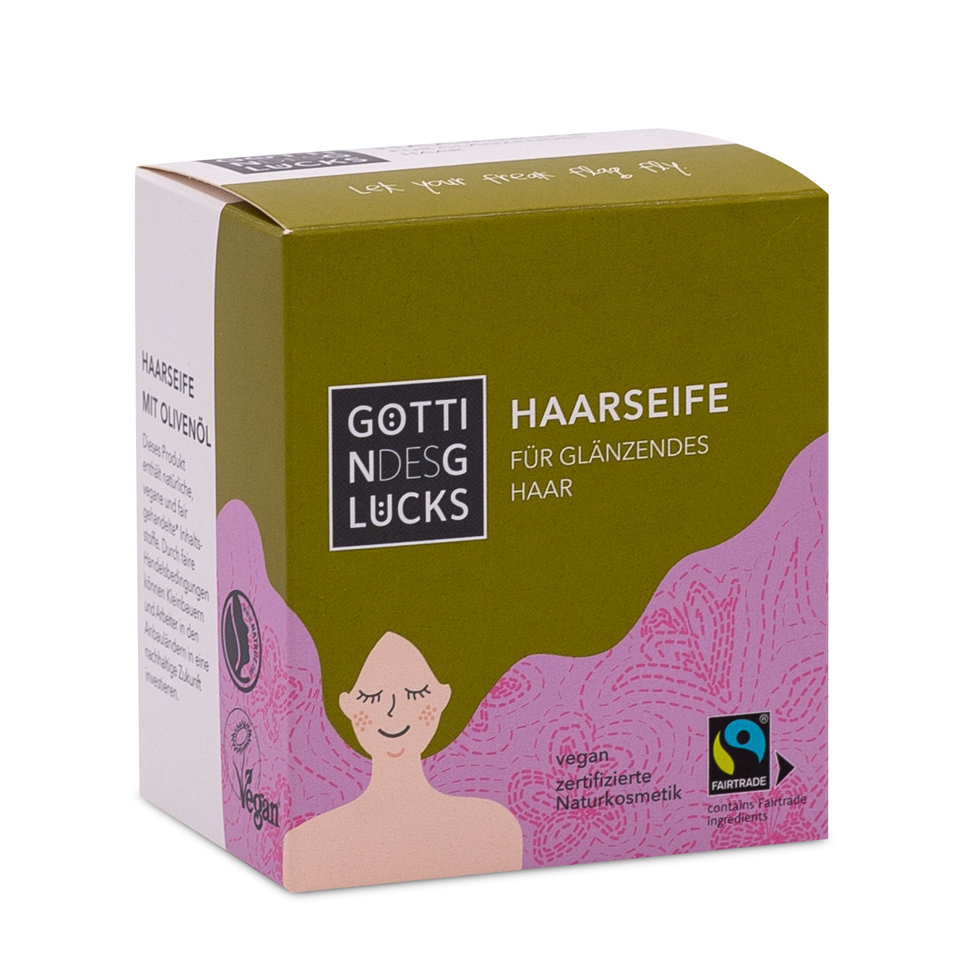 Eine Schachtel Götterglücks Haarseife für glänzendes Haar mit einer stilisierten Illustration einer lächelnden Frau mit wallendem rosa Haar. Auf der Verpackung sind die Logos für vegane, zertifizierte Naturkosmetik und Fairtrade abgebildet.
