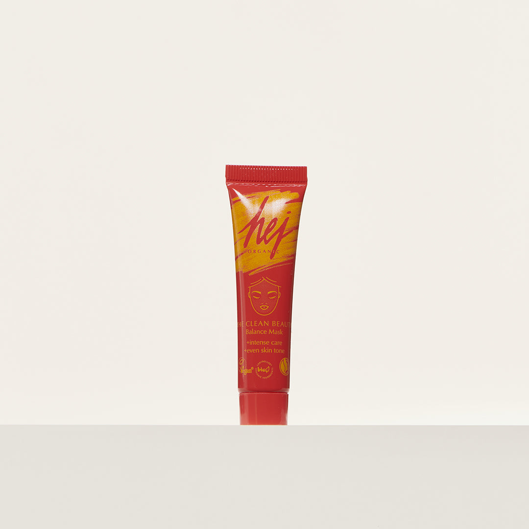 Rote Tube einer Balance-Maske mit gelber Schrift auf einem weißen Hintergrund.