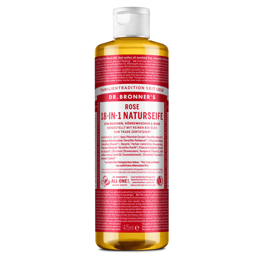 Eine Flasche Dr. Bronners Rose 18-in-1 Pure-Castile Liquid Soap mit einem roten Etikett, auf dem Produktdetails und Inhaltsstoffe angegeben sind, mit einer weißen Kappe und einer transparenten Flasche, die den Inhalt der Seife zeigt.