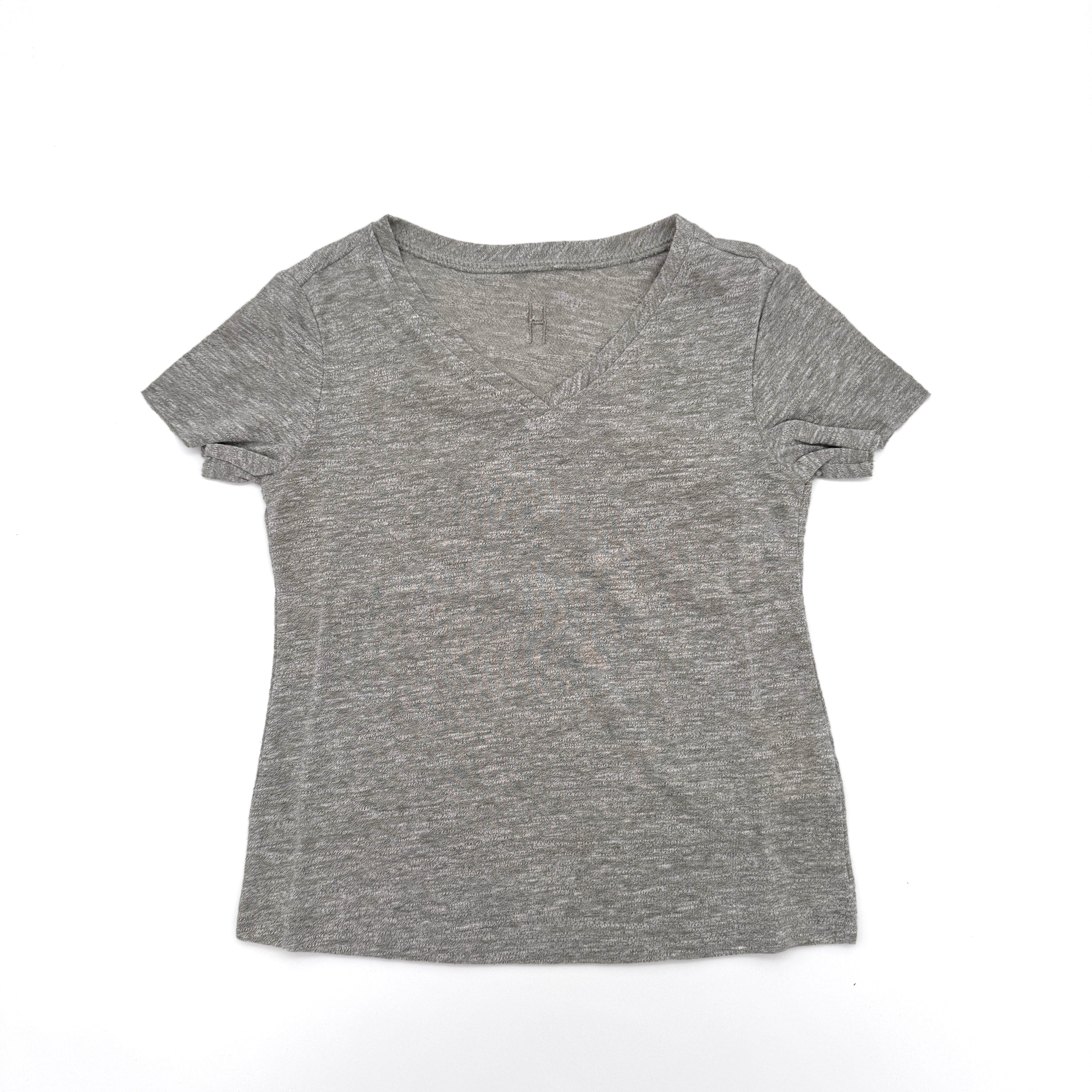 Ein einfarbiges, kurzärmeliges T-Shirt mit grauem V-Ausschnitt liegt flach auf einem weißen Hintergrund.