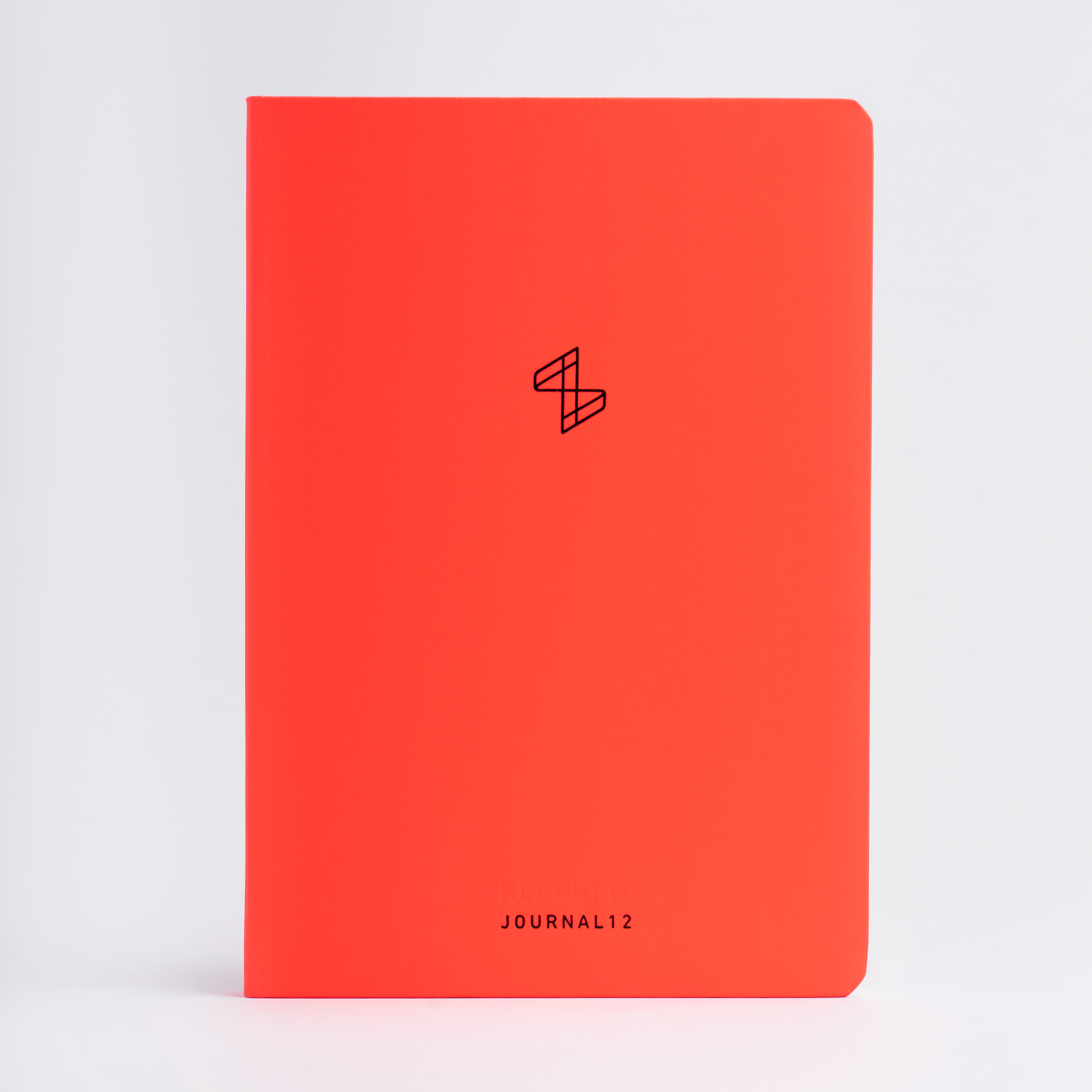 Rotes Notizbuch mit Logo und dem Text „JOURNAL 12“ auf weißem Hintergrund.