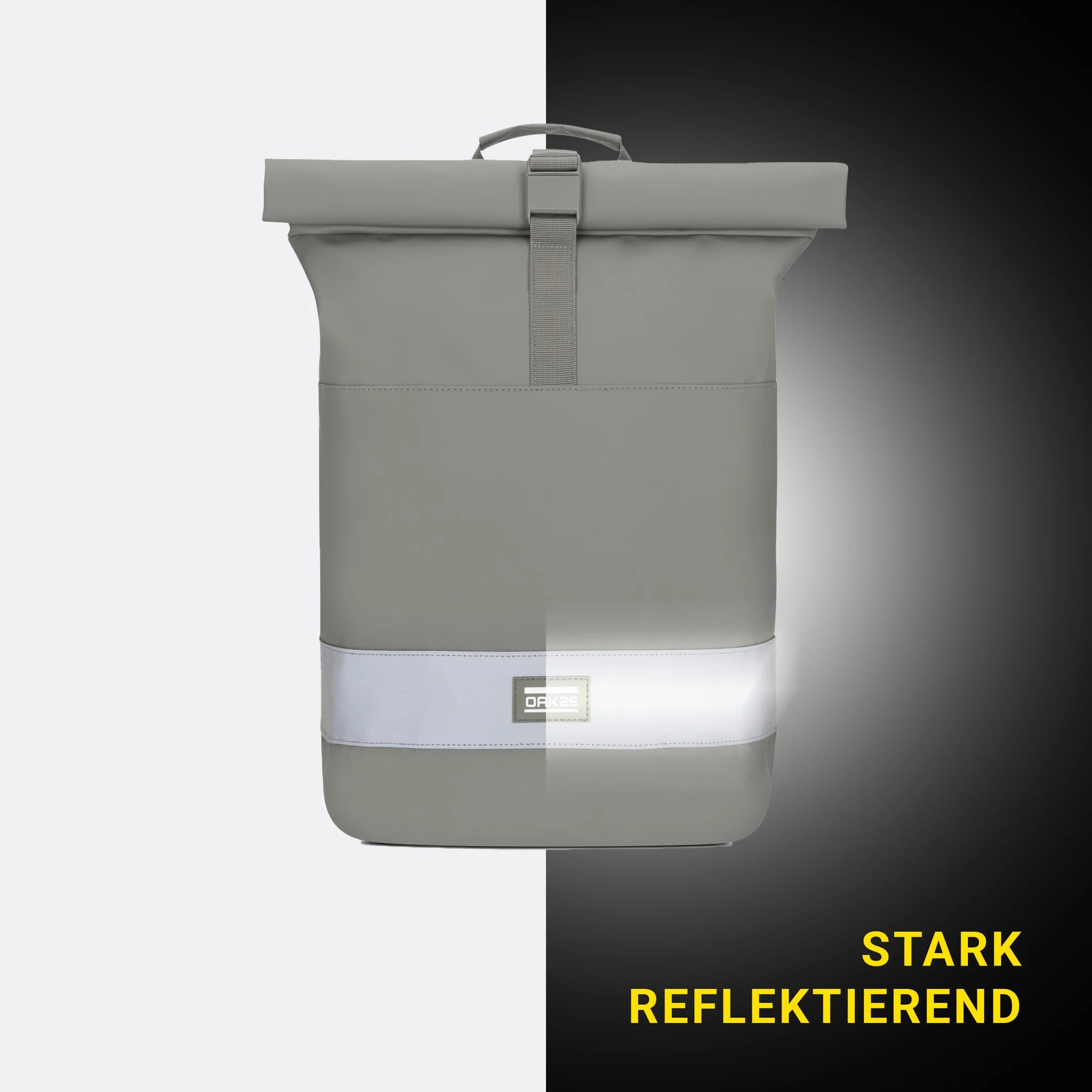Ein hellgrauer Rolltop-Rucksack mit einem reflektierenden horizontalen Streifen ist vor einem schwarz-weiß geteilten Hintergrund abgebildet. Der Schriftzug "Stark reflektierend" erscheint in gelber Schrift unten rechts.