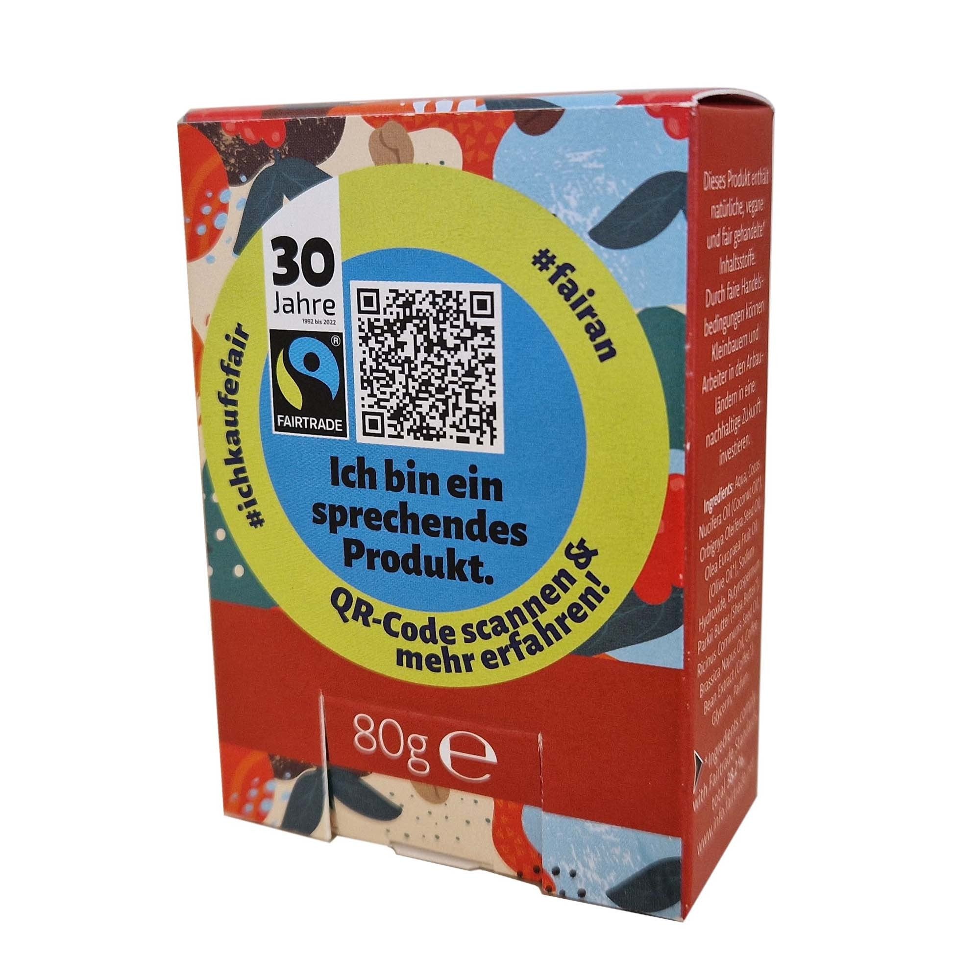 Eine bunte 80g-Produktbox mit deutschem Text, einem QR-Code und dem Fairtrade-Logo. Der Text lautet Ich bin ein sprechendes Produkt. QR-Code scannen & mehr erfahren! auf einem farbenfrohen Hintergrund.