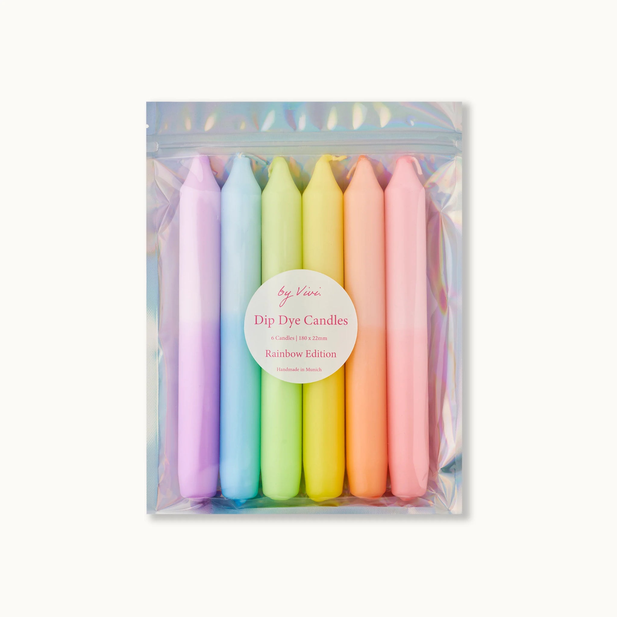 Sechs pastellfarbene Kerzen in einer Verpackung, beschriftet mit "Dip Dye Candles, Rainbow Edition, Handmade in Munich".