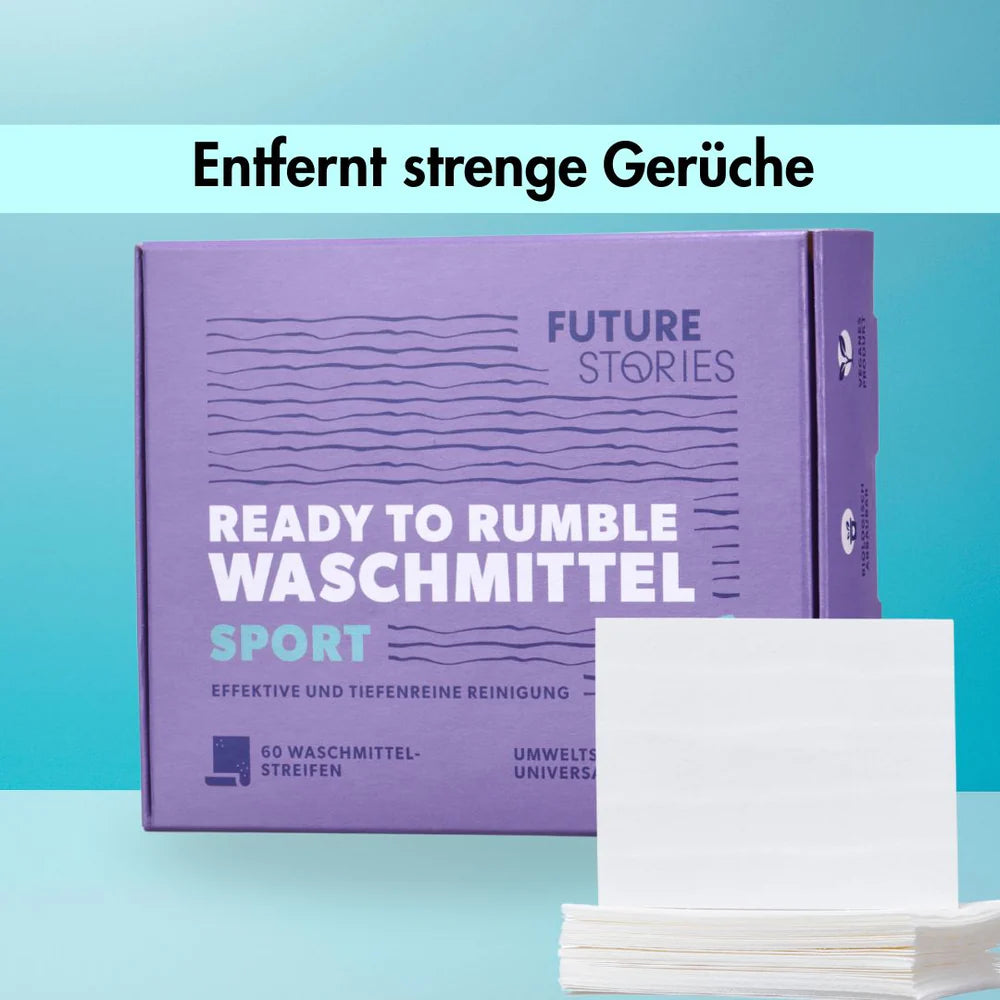 Lila Schachtel mit Ready to Rumble Waschmittel Sport Waschmittelstreifen von Future Stories, mit weißen Streifen auf der Vorderseite. Der Text darüber lautet Entfernt strenge Gerüche auf blauem Hintergrund.
