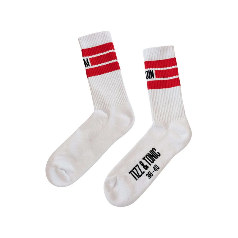 Ein Paar weiße Socken mit zwei roten Streifen am oberen Ende und schwarzem Text an den Zehen mit der Aufschrift TIZZ & TONC 38-40. Die Socken sind flach auf einem weißen Hintergrund ausgebreitet.