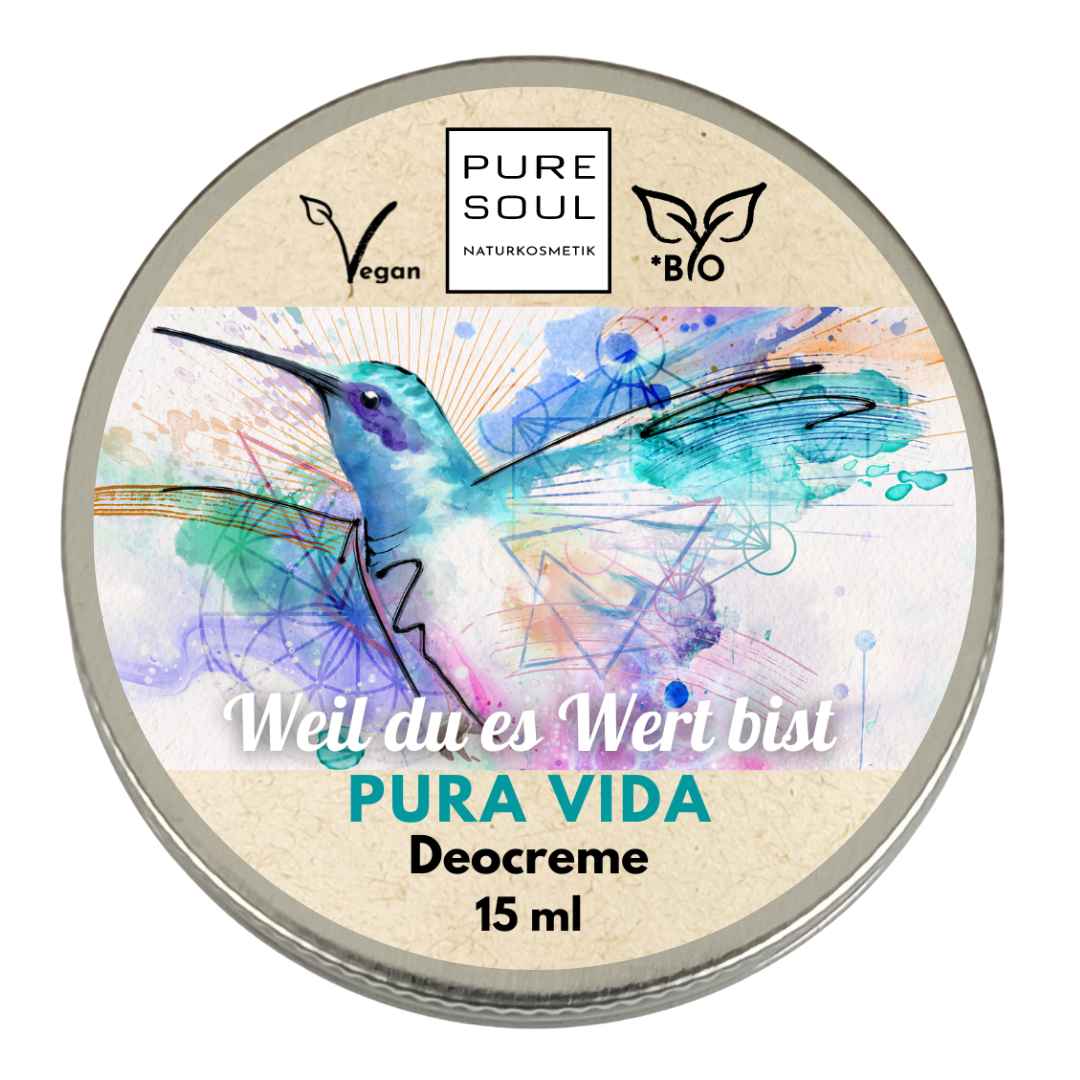 Eine runde Dose Pure Soul Deocreme mit einem farbenfrohen Kolibri in Aquarelltechnik und einem Text in Deutsch und Spanisch, der darauf hinweist, dass die Creme vegan und biologisch ist und eine Größe von 15 ml hat.