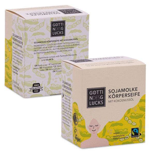 Zwei Schachteln Göttin des Glücks Sojamilch Körperseife mit Kokosnussöl, mit umweltfreundlichen und veganen Etiketten, hellgelber Verpackung und illustrierten Designs.